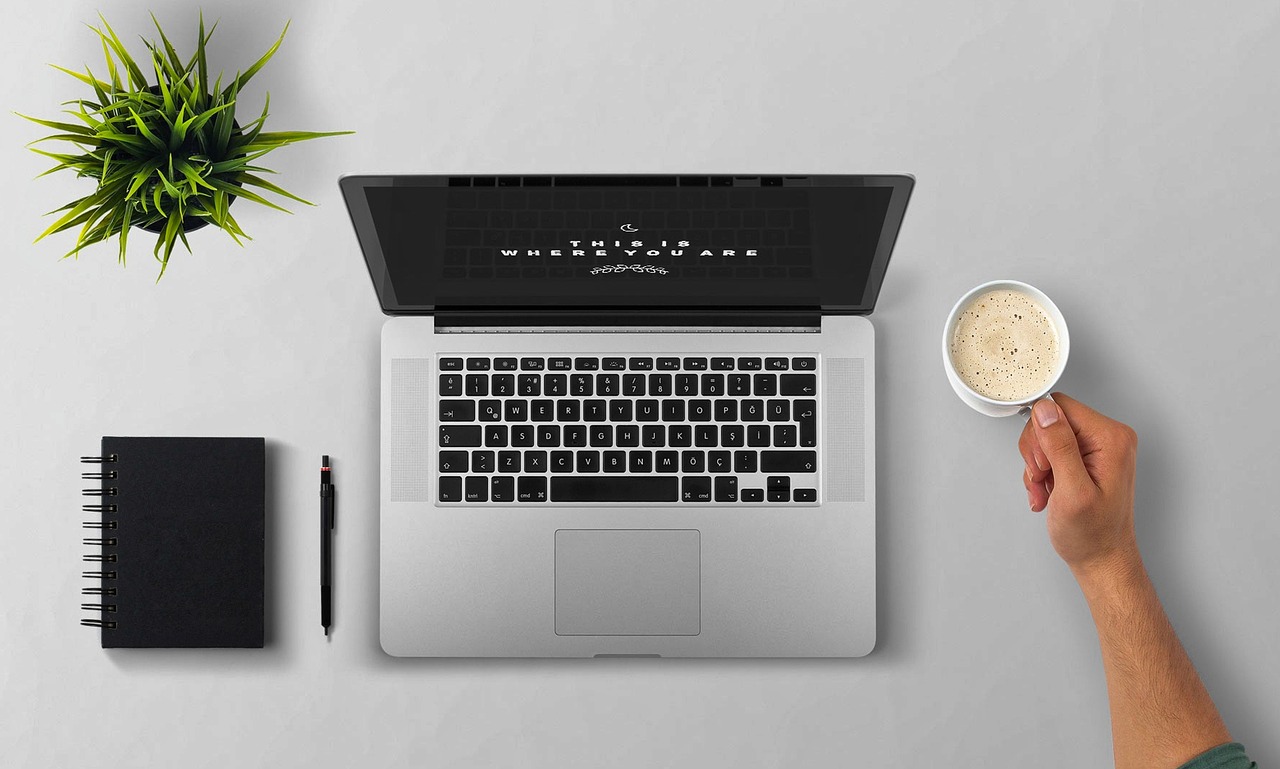 Laptop, coffee, arm — Caring for Hearts: Dr. Hari Saini's Vigilance in Cardiac Wellbeing